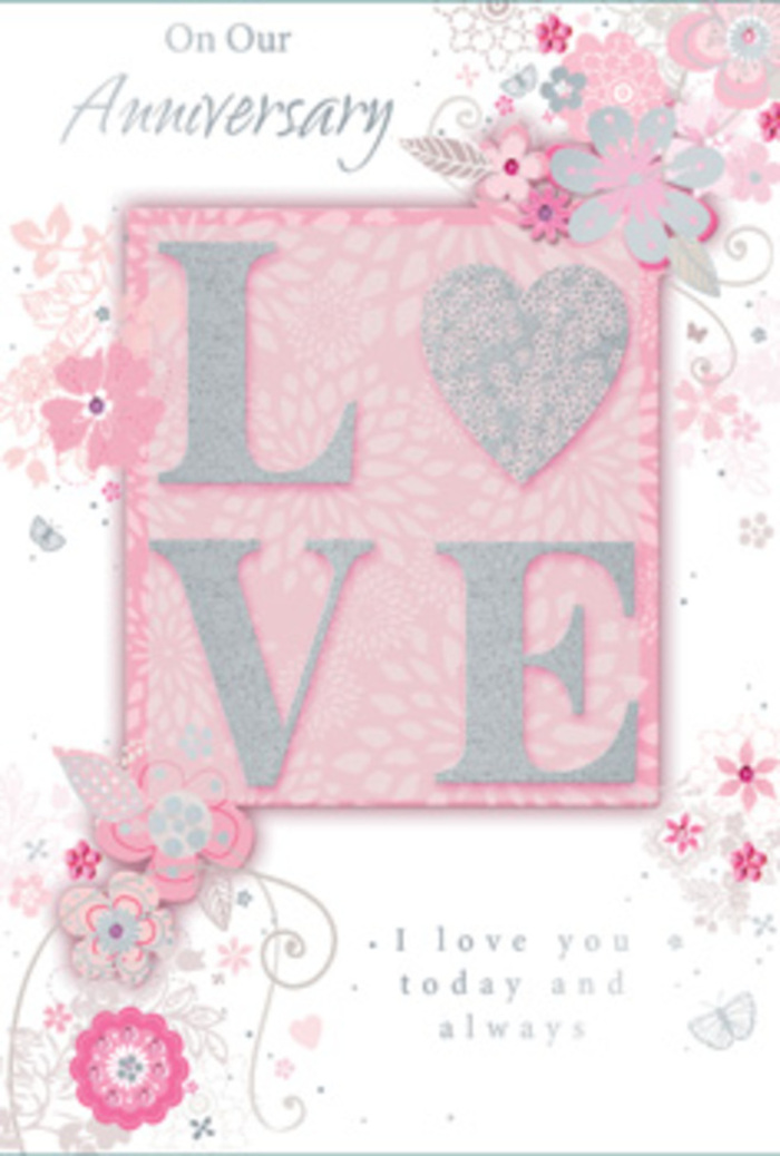 This photograph shows an anniversary card opened and resting against a neutral surface, its design evoking the feeling of stepping into a sunlit room where love has quietly grown over time. The focal motif is the word LOVE, placed prominently and finished with a frosted glitter effect that shimmers softly, rather than sparkling harshly, like morning light on pale petals. The raised texture of the letters suggests a pleasing tactility, inviting the recipient to trace them with their fingertips in the same unhurried way a customer might explore the textures of blooms and foliage at a local Bexleyheath florist. Around this central word, a drift of hand-drawn flowers, slim leaves, and airy sprays frames the card. Their colours blend blush pink, lilac-tinged tones, and soft ivory on a warm pink background, creating an impression of a pastel bouquet loosely arranged with plenty of breathing space. Filigree lines, dainty leaves, and tiny, almost-hidden butterflies weave through the composition, suggesting movement, like the light flutter of petals in a gentle breeze. The illustration style is delicate and controlled, reminiscent of a florist sketching ideas for a romantic anniversary arrangement using seasonal blooms. Below or alongside the floral pattern, a tender message reading I love you today and always sits in a graceful, understated typeface. The lettering is calm and confident, complementing rather than competing with the decorative elements. Overall, the card conveys warmth, gratitude, and quiet devotion, the way a carefully chosen hand-tied bouquet might greet someone returning home to Bexleyheath after a long day. It feels personal and reflective, ideal for marking an anniversary where the focus is on shared history, ongoing commitment, and simple, heartfelt sentiment.